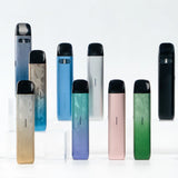 Collection of colorful Caliburn G4 vape devices on clear stands, Canadian vape store display